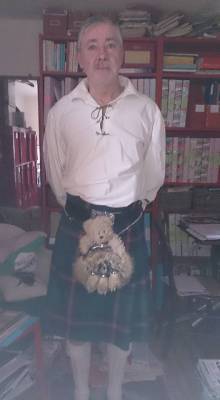 Photo of Gordon in Highland dress with a teddy bear in his sporran