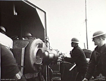 Crew of gunboat HMS Ladybird operating a 6-inch 50-caliber Mk XIII gun during the bombardment of Bardia, Libya, 2 Jan 1941 (Australian War Memorial)