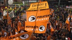 Supporters of German wing of Pirate Party (Piraten Partei) wave their flags during rally against state and corporate surveillance policies in Berlin