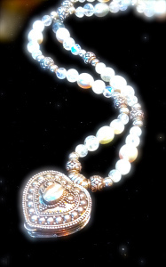 Queen Rose paused and slowly presented her daughter with a finely tooled, heart-shaped locket held on a delicate necklace of shimmering pearls and crystals. Princess Amethyst tenderly opened it to find bits of purple, pink and white crystals sparkling inside. “This is a piece of yourself so you do not give it all away,” her mother said. Excerpt from Gifts of the Crysnix 