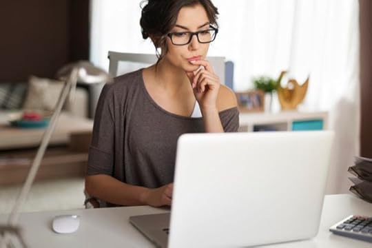 Woman at desk studying computer screen