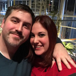 Us standing in front of the strangely inexplicable trash sculpture at McCaw Hall.