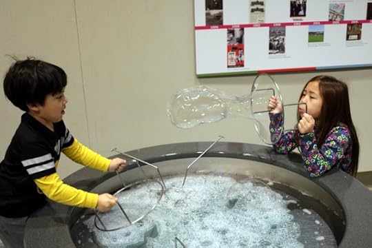 SteelyKid blowing a bubble toward The Pip, at MiSci.