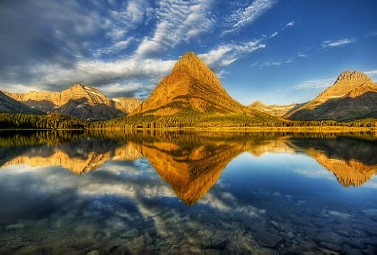 Mountains at the Glacier National Park reflected perfectly in a lake