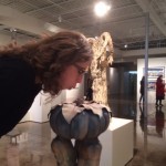 Kelsey Karper blowing into musical sculpture.