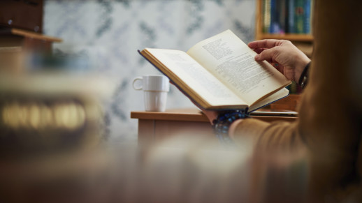 Close-up of human hands with book