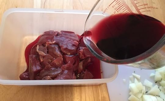 Adding wine, water, and vinegar to marinade