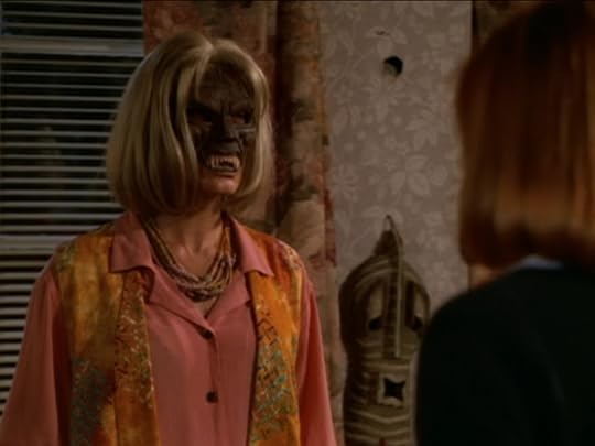 Pat, exactly as I described before, but now with the fanged tribal mask fused to her face.
