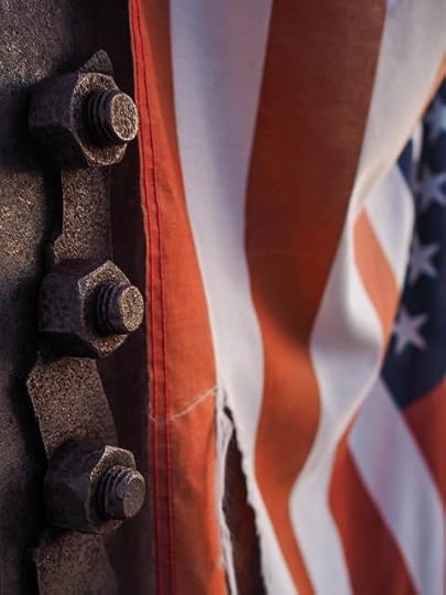 Torn US flag on metal bridge