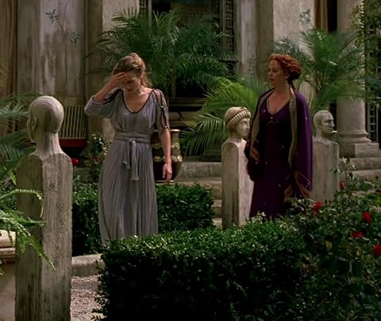 Octavia in a loose, flowing lavender dress, Atia in a tight, structured dark purple dress.