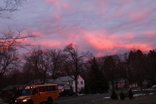 Clouds at sunrise, with the bus picking up the kid across the street.