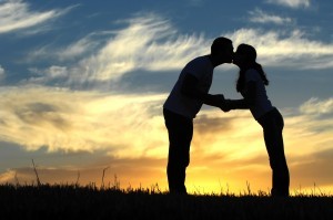 Couple kissing in sunset