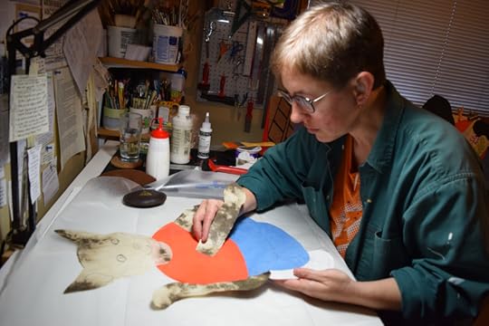 creating a cat character out of cut handmade paper for a public art project