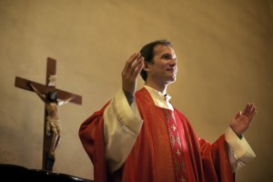 Catholic priest on altar praying during mass