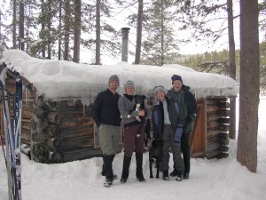 family in front of cabin