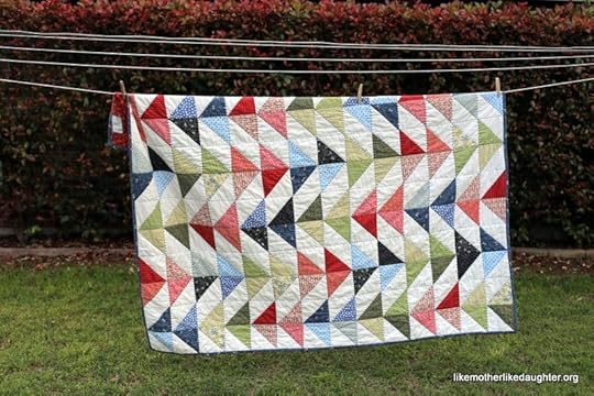 A bright and colorful modern half-square triangle quilt for a little boy's big boy bed.