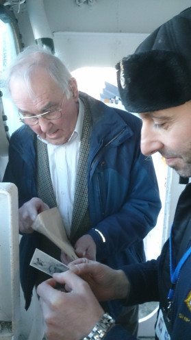 Photo of my dad with tour guide looking at old photos
