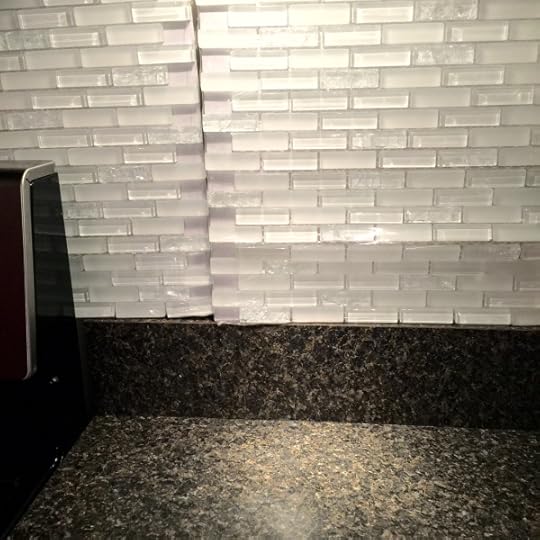 We selected this crystal and glass backsplash from Lowe's. The smaller tiles appeal to us, and we love the mixture of pieces in it. (My kids are holding it up for the photo...thanks, loves).