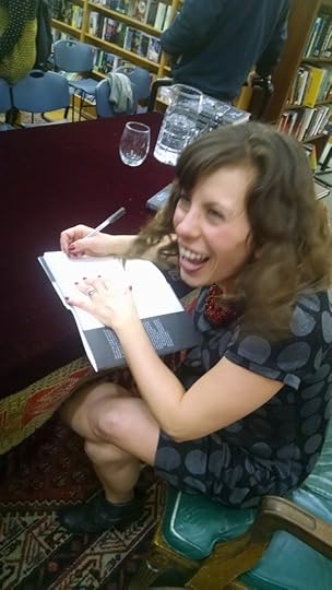 Pam Moore signing a copy of There's No Room For Fear in a Burley Trailer