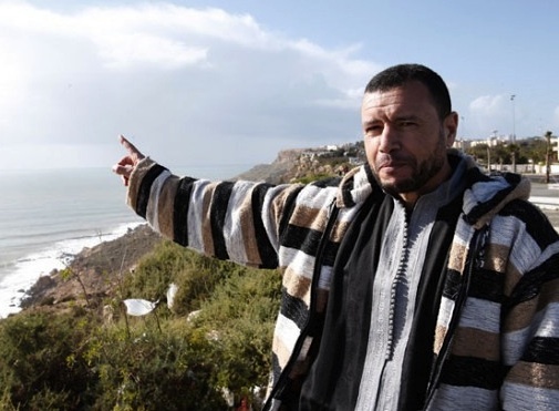 Former Guantanamo prisoner Younous Chekkouri points at the Atlantic Ocean during an interview with the Associated Press (AP Photo/Abdeljalil Bounhar).