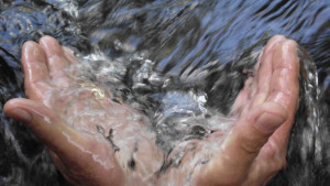hands in river