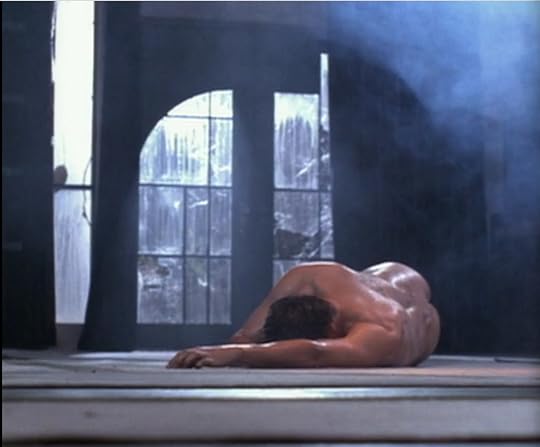 Angel, naked and oily, posed like a renaissance painting of a generic dead saint or something. Translation: lots of ripply muscular back, partial view of his butt.