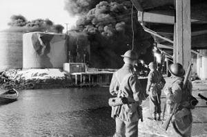 Raid on the Lofoten Islands: commandos watching fish oil tanks burning, 4 March 1941 (Imperial War Museum)