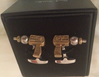 Comic books, purple dress shoes, and these ray run cufflinks. I'm not on the hunt four some Flintstone cuffs.