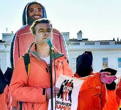 Andy Worthington calling for the closure of Guantanamo outside the White House on January 11, 2016, the 14th anniversary of the opening of the prison. Behind him is the giant inflatable figure of Shaker Aamer that was at the heart of the We Stand With Shaker campaign (Photo: Justin Norman).