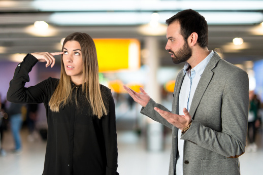 Businesswoman making a crazy gesture over white background