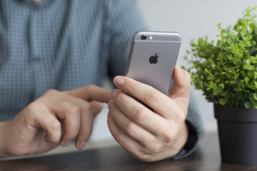 Alushta, Russia - November 20, 2014: Man holding in the hand a new iPhone 6 Space Gray. iPhone 6 was created and developed by the Apple inc.