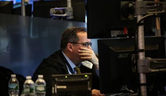 A trader works on the floor of the New York Stock Exchange (NYSE) in New York, U.S., on Friday, Jan. 15, 2016. Stocks tumbled around the world, with U.S. equities headed for their lowest levels since August, and bonds and gold jumped as oil's plunge below $30 sent markets reeling. Treasuries extended gains as economic data and earnings added to concern that global growth is faltering. Photographer: Chris Goodney/Bloomberg via Getty Images