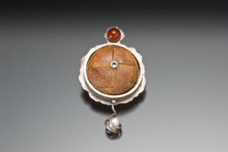 Image from Robert Danick; pin made from a leather button from a father's favorite jacket, pearl, and semi-precious stones. 