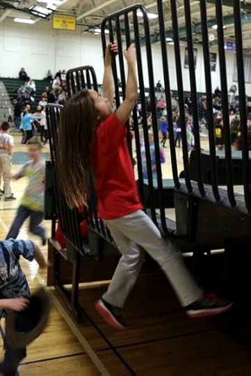 SteelyKid climbing the railing at the Odyssey of the Mind party.
