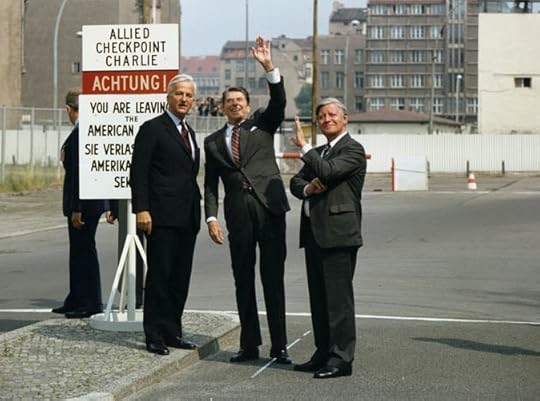 Photograph of Berlin Mayor Richard von Weizsaecker, President Reagan, and Chancellor Helmut Schmidt at Checkpoint Charlie at the Berlin Wall, November 1982. Public domain courtesy Ronald Reagan Library via Wikimedia Commons.