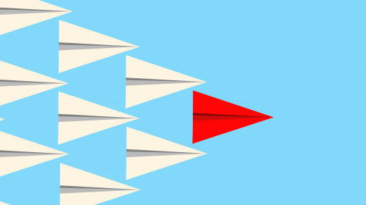 Leadership concept illuctration showing a red paper plane leading a group of white planes. Vector format available.