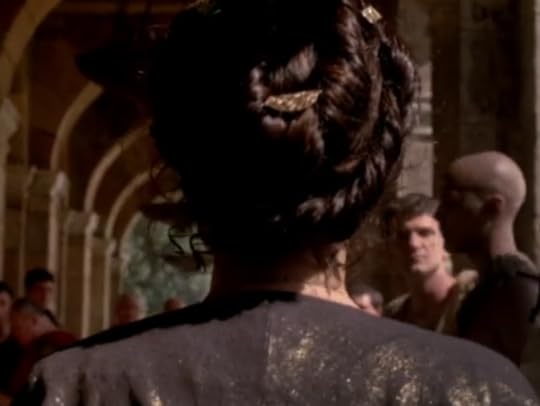Cleopatra's hair is a configuration of romantic-looking coils held with gold ornaments.