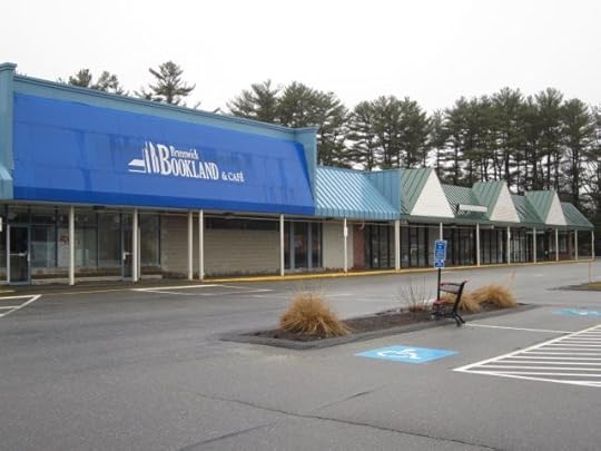 Three other storefronts next to Bookland are empty.