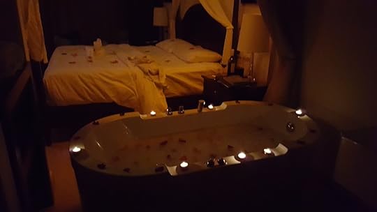 The jacuzzi tub, surrounded by candles, with a bubble bath inside and rose petals on top. It's directly beside a huge four poster bed with rose petals sprinkled all over the duvet.