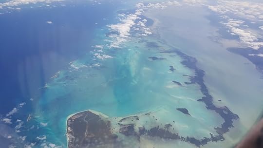 A view from the plane window of the sea and one of Cuba's little island chains.
