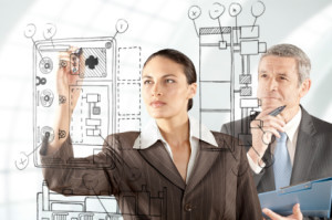 Engineers planning strategy with sketch of their latest design.