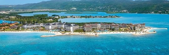 A peninsula with two sprawling resorts on it. The water is super blue.