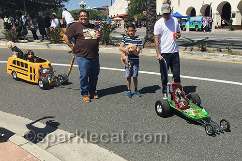 family with dogs in toy cars at Blessing of the Animals