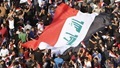 Supporters of prominent Iraqi Shi'ite cleric Moqtada al-Sadr display a huge Iraqi flag during a protest against government corruption at Tahrir Square in Baghdad, Iraq March 11, 2016. REUTERS/Ahmed Saad