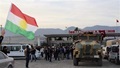 A man waves a Kurdistan flag as a Turkish military truck escorts a convoy of peshmerga vehicles at Habur border gate, which separates Turkey from Iraq, near the town of Silopi in southeastern Turkey, October 29, 2014. Iraqi peshmerga fighters arrived in southeastern Turkey early on Wednesday ahead of their planned deployment to the Syrian town of Kobani to help fellow Kurds repel an Islamic State advance, a Reuters witness said. REUTERS/Kadir Baris