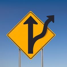 An off-road traffic sign post over a clear blue sky showing an alternative direction - a clipping path is included to separate sign from sky.