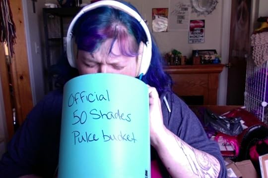 Me, miming barfing into a wastebasket I've sloppily written 
