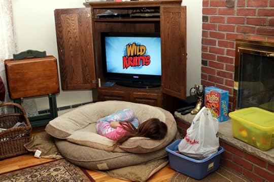 Watching tv from the dog's bed.