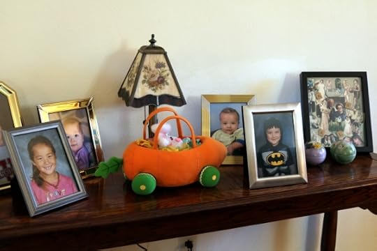 The photo shelf in my parent's living room, with school pictures of the kids.