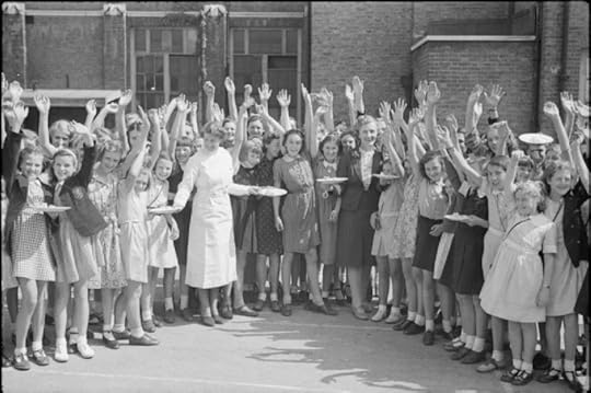 British schoolchildren wave for the camera as they receive plates of bacon and eggs, imported from America as part of the Lend-Lease program, 1941 (Imperial War Museum)